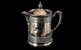 Large American Silver Plated Iced Water Jug with a Shaped Spout and Beaten Body Pattern with