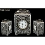 A Victorian Silver Cased Miniature Clock embossed scroll floral design with birds,