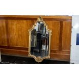 Rococo Style Wall Mirror of Large Size, a lovely and striking, ornate mirror with elaborate borders;