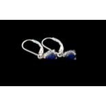 Sapphire Solitaire Drop Earrings, a timeless design with pear cut solitaire blue sapphires suspended