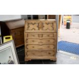 A Modern Light Oak Bureau, fall front above four graduating drawers in a Jacobean style.