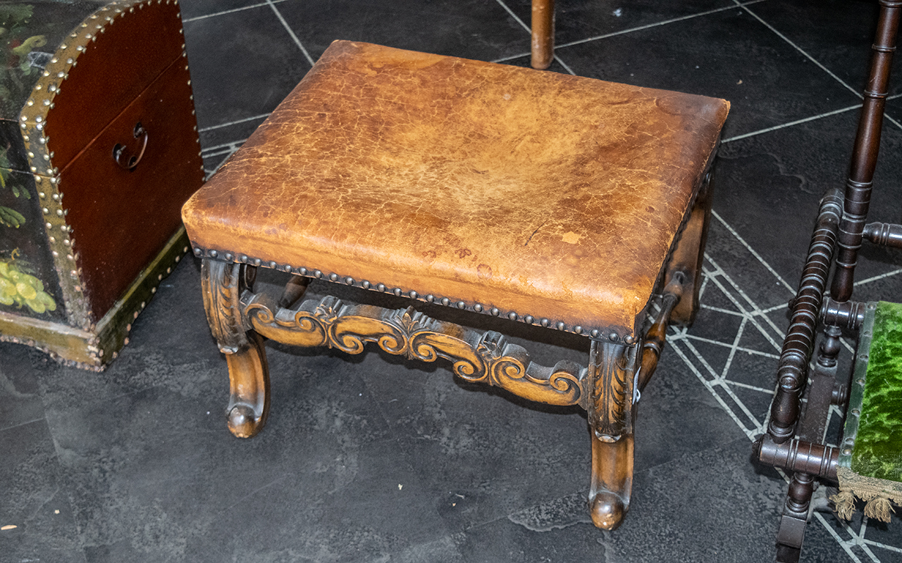 A William & Mary Style Cabriole Leg Stool with a leather seat, worn, with brass studs. Height 14''.