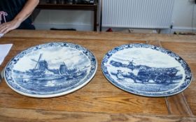 Two Large Dutch Delft Chargers depicting canal scenes and Dutch women with a dog cart, each 16