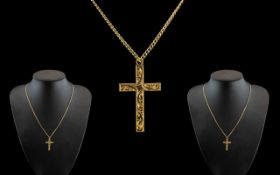 A 9ct Gold Pendant Cross stamped 9ct suspended on a yellow metal 16 inch chain. 3.3 grams.