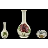 Moorcroft Handpainted Tubelined Bottle Shaped Vase 'Hibiscus' Design, on cream ground.