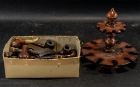 A Mahogany Pipe Stand, with a collection of twenty pipes, to include some carved, mainly wood.