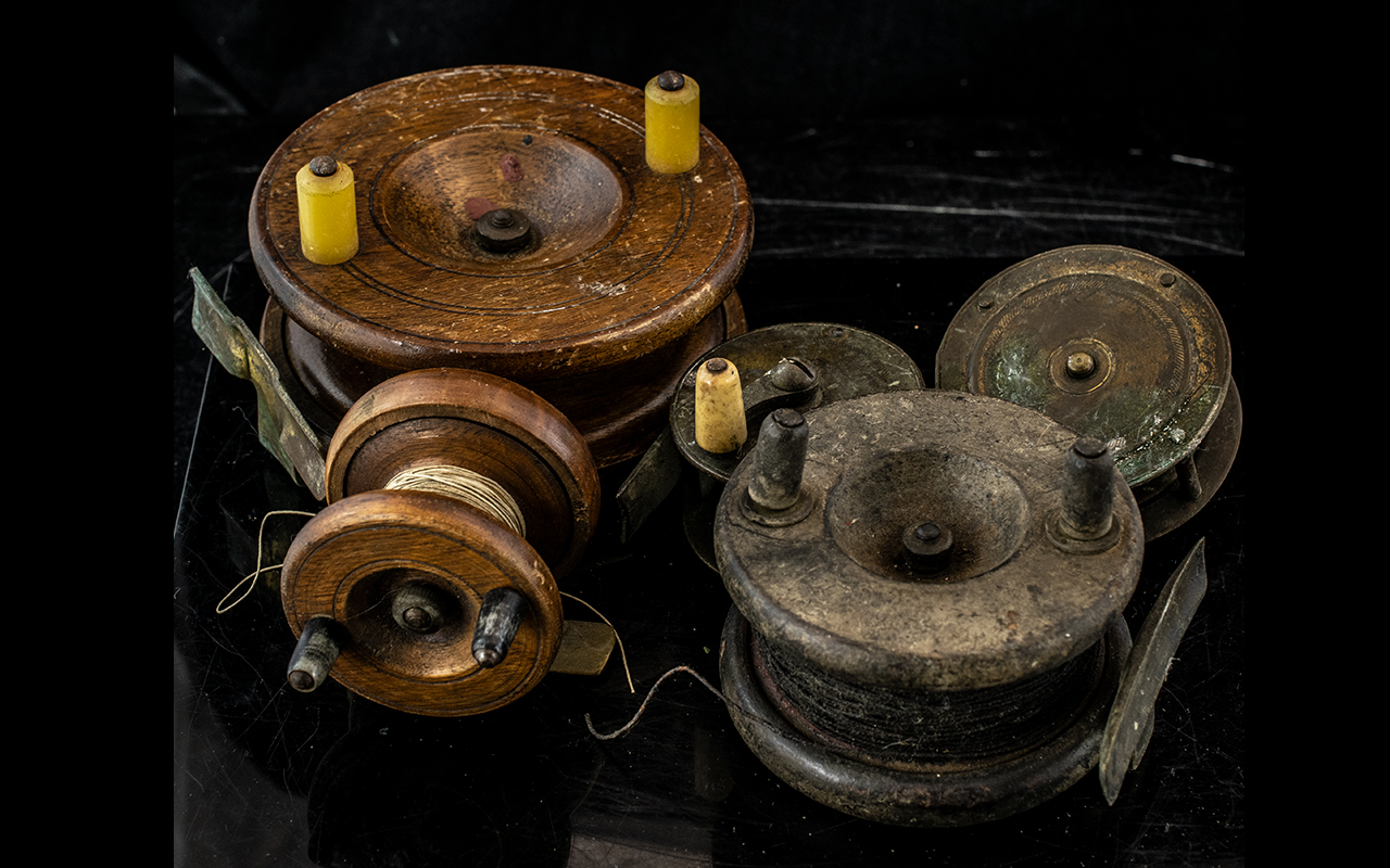 Five Vintage Fishing Reels comprising three various sizes of wooden reel,