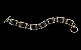 A Vintage Sterling Silver Well Made Bracelet Set with Seven Polished Black Stones,