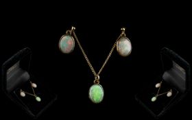 A 9ct Gold Mounted Opal Pendant and Earring Set plain rub over setting with matching plain drop