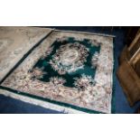 Large Green Ground Embossed Chinese Carpet with a decorative floral border; in good condition,