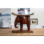 An African Style Elephant Stool in hardwood, varnished. Measures 18" high x 20" length x 10" width.