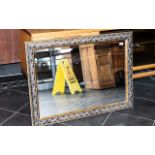 A Rectangular Bevelled Glass Mirror, with moulded acanthus frame. Measures 30" x 42".