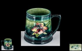 William Moorcroft Tubelined Tankard ' Orchids ' Design on Blue and Green Ground. c.1930's. Signed W.