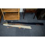 Two Unmarked Cane Two Piece Fishing Rods, both in canvas holders,