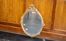 Oval Bevelled Glass Mirror in Gold Rococo Style Frame, measures 30" x 21" approx.
