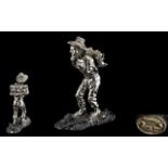 Silver Overlaid Figure of a Man Carrying a Bundle of Wood, stamped 999 'Zampeld',