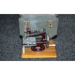 Mid 20th Century Child's Miniature Sewing Machine, in chrome with burgundy enamel frame.