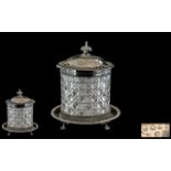 Victorian Cut Glass Biscuit Barrel with a silvered metal base on clawed feet,