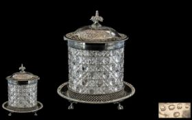 Victorian Cut Glass Biscuit Barrel with a silvered metal base on clawed feet,