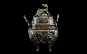 A Chinese Bronze Sensor, twin handled the cover with stylised dragon. Height 7".