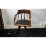 Antique American Oak Swivel Desk Chair of typical form, supported on three shaped legs,