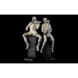 Pair of Jazz Player Book Ends, raised on black base, depicting two men,