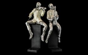 Pair of Jazz Player Book Ends, raised on black base, depicting two men,