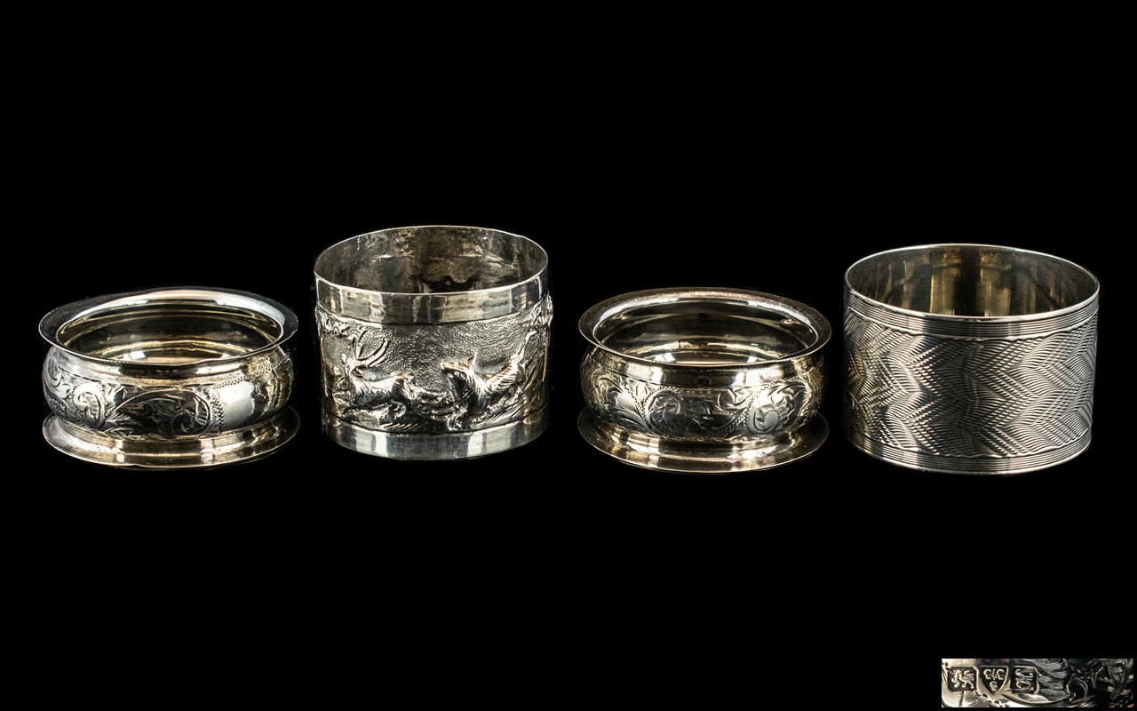 Three Silver Napkin Rings, together with a white metal napkin ring with hunting scene, marked V 90.