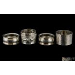 Three Silver Napkin Rings, together with a white metal napkin ring with hunting scene, marked V 90.