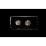 Pair of Diamond Starburst Cluster Stud Earrings, closely set baguette cut diamonds,