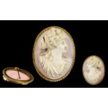 A Pink Coral Carved Cameo Brooch of a maiden facing right.