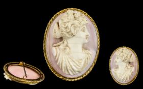 A Pink Coral Carved Cameo Brooch of a maiden facing right.