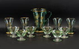 A Vintage Water Jug & Four Glasses, aqua colour glass decorated with gold leaf design, together with