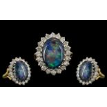 A 18ct Opal and Diamond Cluster Ring central black opal doublet,