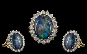 A 18ct Opal and Diamond Cluster Ring central black opal doublet,