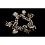 A Good Quality - Vintage Sterling Silver Charm Bracelet Loaded with 6 Quality Silver Charms.