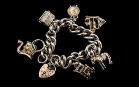 A Good Quality - Vintage Sterling Silver Charm Bracelet Loaded with 6 Quality Silver Charms.