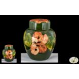 Moorcroft Tube lined Lidded Ginger Jar ' Coral Hibiscus ' Design on Green Ground. Signed to Base.