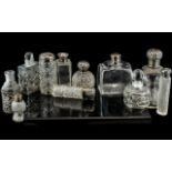 A Collection of Glass Scent Bottles, mostly silver mounted, various shapes and sizes,