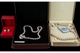 ( 2 ) Boxes of Cultured Coloured Pearls of Matched Sizes with Clasps. 15 Inches In length, With a