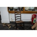 Antique Ladderback Rocking Chair of generic Yorkshire form, with a rush seat, supported on round,
