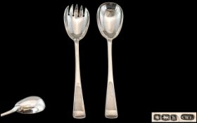 A Fine Pair of Sterling Silver Salad Servers of Plain and Elegant Form.