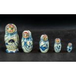 Russian Matryoshka Doll, five graduating doll figures of typical form, signed to the base.