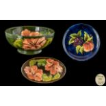 Three Pieces of Moorcroft to include a small Hibiscus Shallow Bowl on a green ground 6 inches,