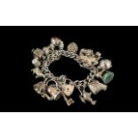 A Superb Vintage Sterling Silver Charm Bracelet Loaded with 16 Excellent Silver Charms.