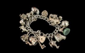 A Superb Vintage Sterling Silver Charm Bracelet Loaded with 16 Excellent Silver Charms.