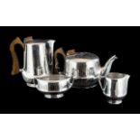 Four Piece Stainless Steel Picquot Ware Set, comprising a Tea Pot, Hot Water/Coffee Jug,