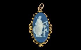 A Wedgwood Cameo Pendant oval classical scene in an oval mount. Approx 1.5 inches.