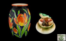 Czechoslovakian Vase in dark blue base with bright orange tulip design, measures 11" tall,