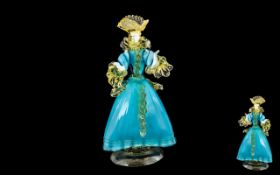 Murano Glass Lady Figurine, dressed in turquoise blue dress trimmed in pale yellow highlights.